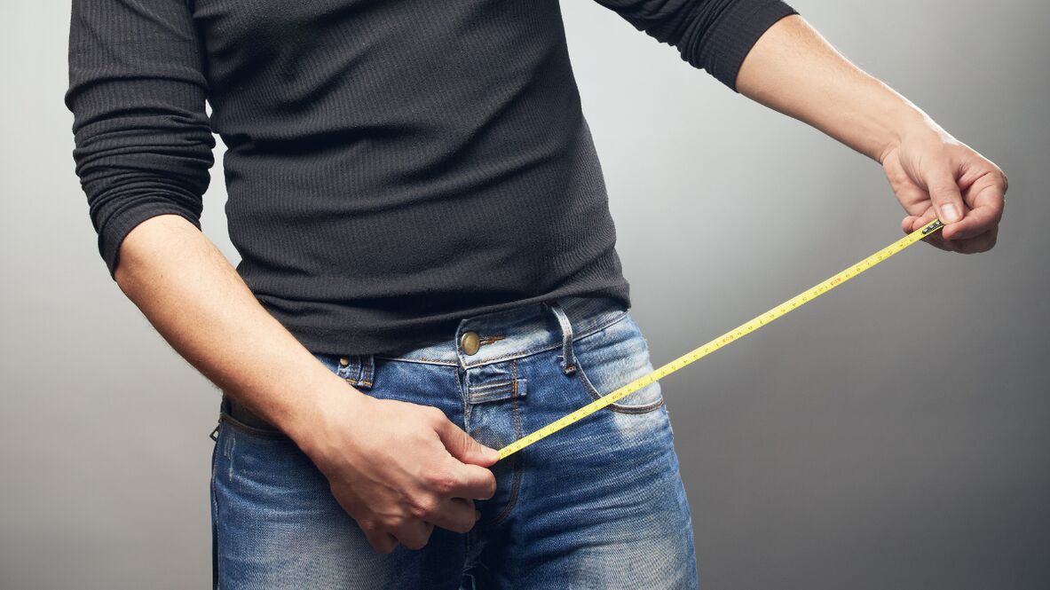 man measuring penis after enlargement