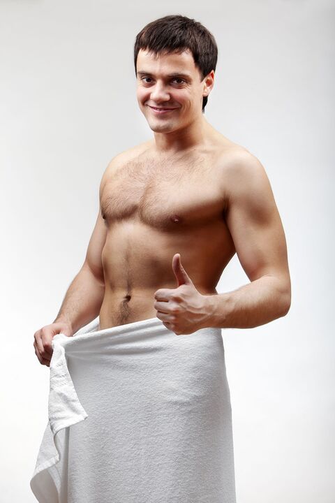 The towel-clad man is pleased with the growing size of his penis